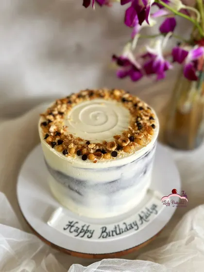 Beauty in simplicity. This is a rich and indulgent chocolate hazelnut naked cake, with a simple marble buttercream finish and a topping of toasted nuts.