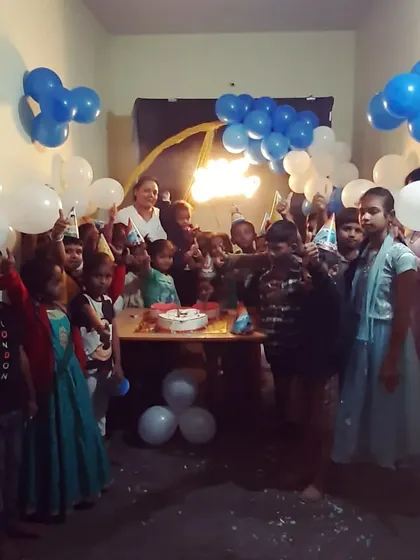 The best part of any party is seeing the happy faces. Here are the kids gathered for a cake cutting in front of the blue and white balloon decorations we set up, all ready to celebrate together.