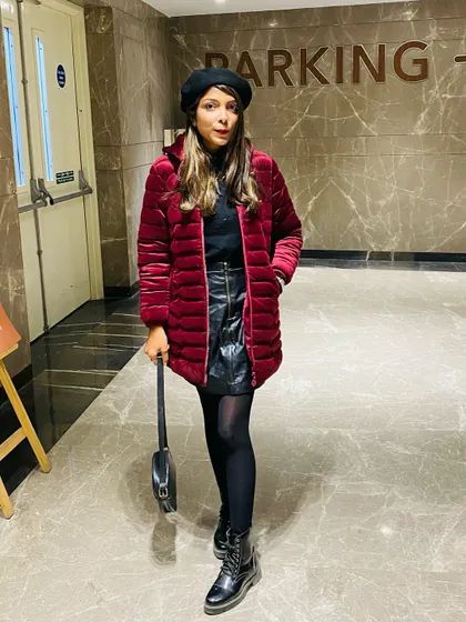 My Christmas vibe in a red velvet puffer coat, leather skirt, and combat boots. This is a festive and edgy look that's great for holiday parties.