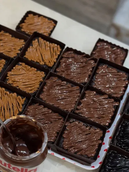 Prepping trays of our popular Nutella and Biscoff brownies for Rakhi orders.