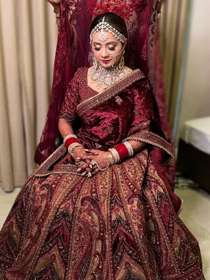 A full-length view of the bride in her magnificent velvet lehenga. My services include draping the dupatta perfectly to complete the regal look.
