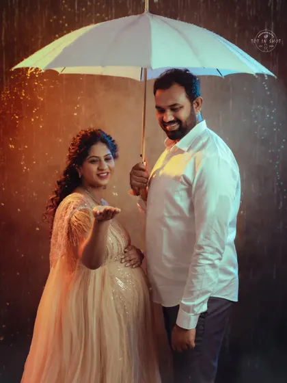 A playful moment in our studio rain setup, as the mom-to-be reaches out to "feel" the drops.
