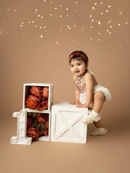 Almost ready to make a move. This first birthday portrait captures the excitement and curiosity of a one-year-old exploring her special birthday set.