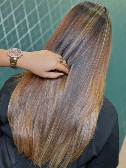 Another view of the sunlit brown hair, showing how the color looks from a different angle. The shine and health of the hair are evident.