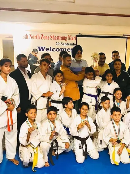 The team after a successful day at the North Zone Shastrang Martial Arts tournament. You can see students of all belt levels with their medals, showing that everyone has a chance to compete.