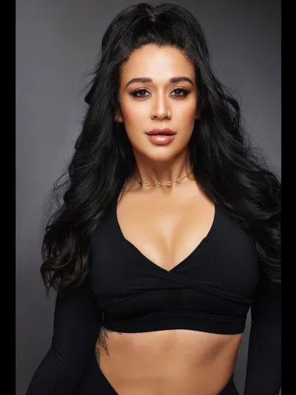 A direct shot showcasing the height and texture of the half-ponytail. The dark, glossy hair looks incredibly healthy and full, perfect for a fitness or beauty campaign.