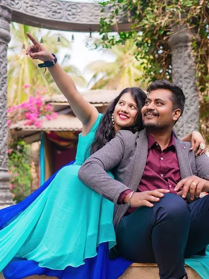 A playful and creative shot of a couple posing on a colorful set piece.