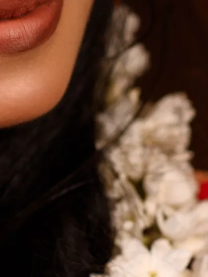 A close-up of a warm, matte brown lipstick. This shade is versatile and works beautifully with both traditional and modern bridal looks.