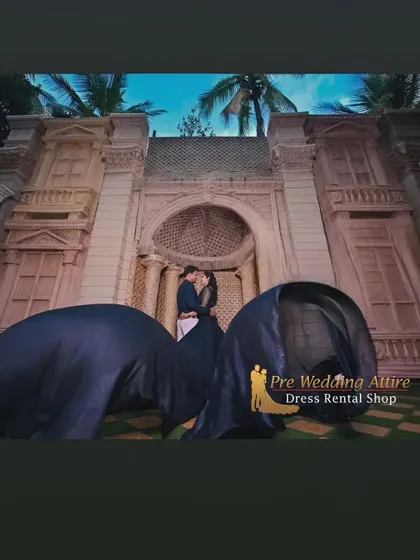 A dramatic, low-angle shot of a couple, with the black flying gown creating a powerful foreground element. This is a great example of using the outfit to create artistic compositions.