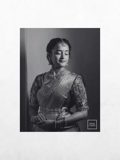 A timeless black and white bridal portrait. The classic edit focuses on her serene expression and the beautiful silhouette of her traditional attire.