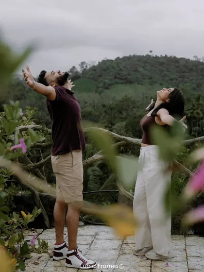 Arms outstretched, embracing the moment and the stunning view. We capture the feeling of freedom and joy in our destination shoots.