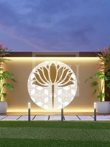 A close-up of the lotus feature wall from the Jaipur project, flanked by flowering trees and illuminated by soft backlighting, creating a stunning focal point.