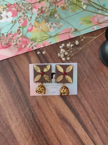 My gotapatti earrings are a festive favorite. These square fabric studs feature golden gotapatti work and a small jhumki drop, available in brown, green, and grey.