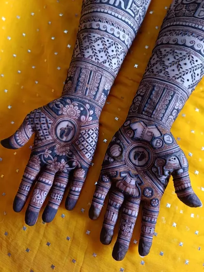Another angle of this detailed baby shower mehendi, highlighting the combination of traditional patterns with fun, modern text and personalized baby-themed elements.