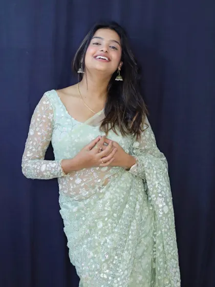 Sonu laughing, a picture of pure joy and elegance in our designer saree.