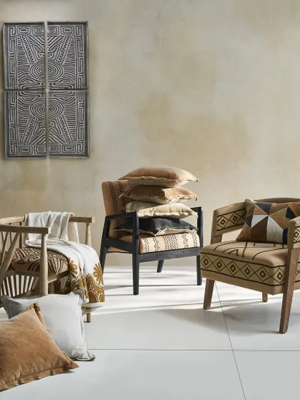 A collection of accent chairs with tribal-inspired patterns. This group shot highlights the variety of designs and the detailed craftsmanship of the upholstery.