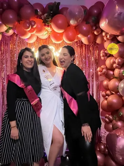 An influencer's bachelorette party in full swing. The chrome balloon arch and fringe backdrop created a fun and festive atmosphere for the bride and her friends.