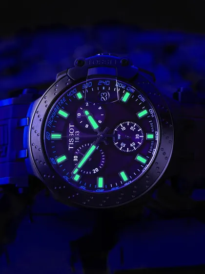 Let it glow. This Tissot watch has incredible lume, and I wanted to capture that electric green-blue glow in the dark. This shot uses UV light to charge the markers and hands, creating a dramatic, moody image that highlights a key feature of the watch.