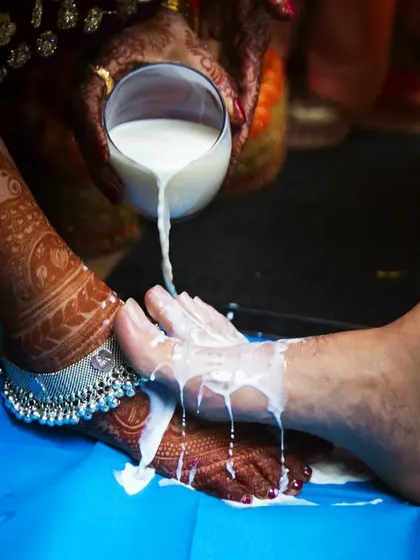 A close-up of the ritual of washing the couple's feet with milk, a tradition rich with symbolism in some Indian cultures. I cherish capturing these intricate details that honor our heritage.