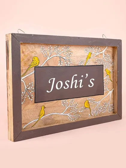 An angled view of the bird-themed nameplate, showing the wooden frame and the depth of the piece. We use solid wood to ensure our nameplates are durable and long-lasting.