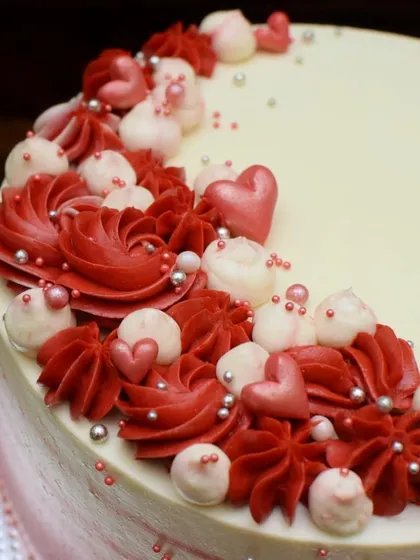 A close-up of the piped details on the red velvet cake. I used different shades of red and pink, along with little edible hearts, to create a romantic look.