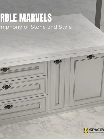 This kitchen island is a true marble marvel, combining a beautiful stone countertop with classic panelled cabinetry. The dark, vintage-style handles provide a striking contrast against the light grey drawers and doors.