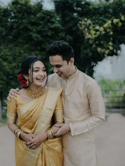 A moment of shared laughter between the couple, showcasing the genuine fun and happiness of their engagement day.