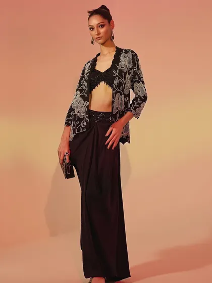A full-length shot of the modern black ensemble. I added a clutch and statement earrings to complete this chic, party-ready look, focusing on a sharp and sophisticated silhouette.