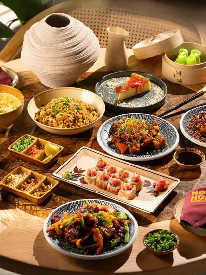 A full-table spread showcasing the variety of a Pan-Asian menu. My goal here is to create a sense of abundance and a feast for the eyes, inviting customers to try everything.