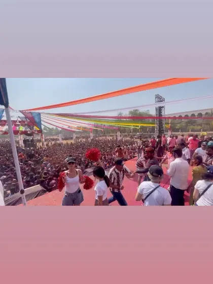 A wide shot of the stage and the massive open-air venue for the Holi concert in Banhatti. The setup is designed for a full-day party with thousands of attendees.