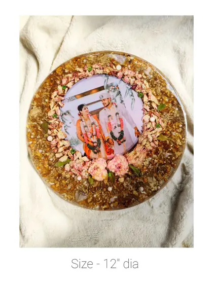 A 12-inch round frame with a beautiful arrangement of preserved flowers around a central photo.