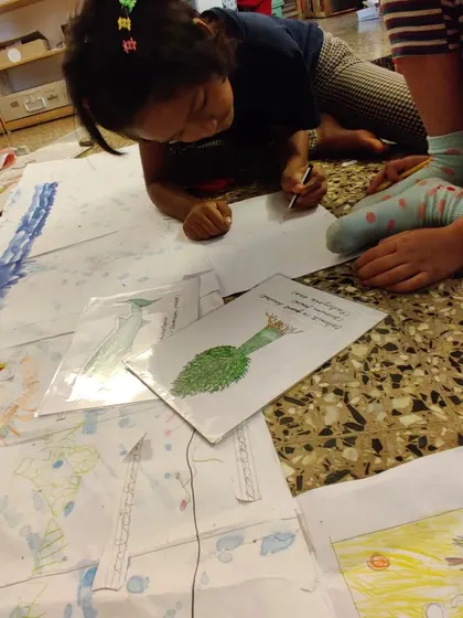 Another view of our "Timeline of Life" project, where children are illustrating different eras of evolution, from ancient plants to early animals.