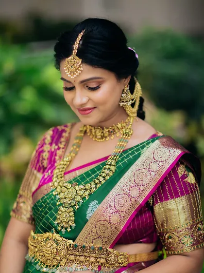 A close-up of the beautiful mom-to-be, showing the intricate details of the choker, haram, and maang tikka from our temple jewellery collection.