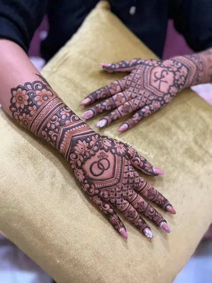 A clear view of the engagement design with interlocking rings and the initial 'K', set against a beautiful floral and geometric background.