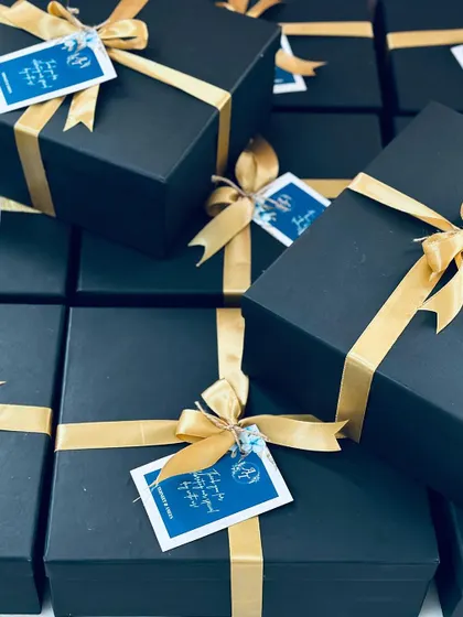 A close-up of the stacked wedding favor boxes, showing the beautiful custom tags.