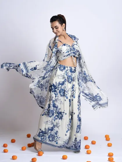 A full-length shot showing a breezy, floral co-ord set. The makeup is soft and romantic, with a focus on fresh skin to match the outfit's aesthetic.