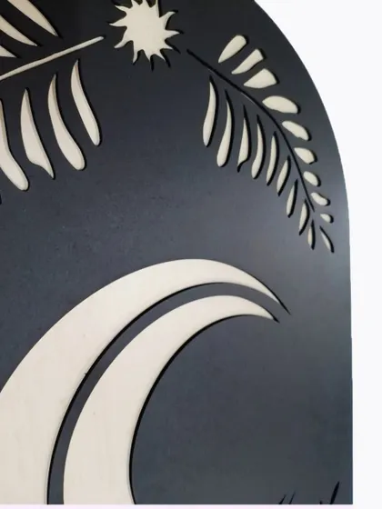 A close-up of our Botanical Moon Sign, showing the delicate, laser-cut fern-like leaves framing the crescent moon.