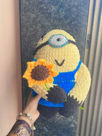 Holding up the finished Minion doll to show its size. Each custom piece is made to your specifications, so you can choose how big or small you want your character to be.