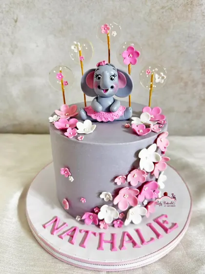 A full view of this sweet elephant-themed cake, perfect for a little girl's birthday.