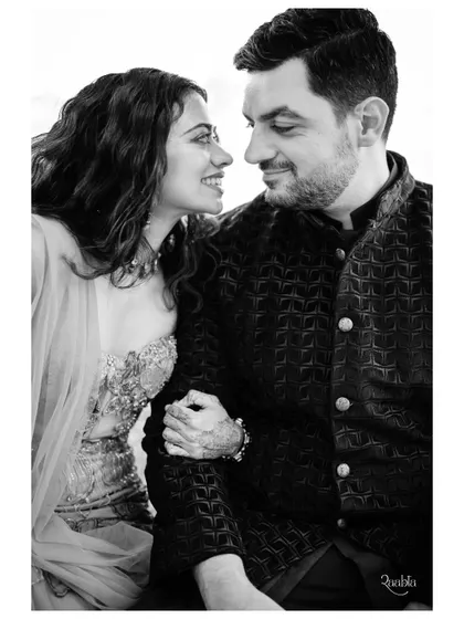 A black and white portrait capturing a quiet, loving glance between the couple during their welcome event in Malta.