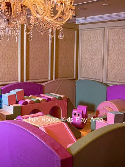 An indoor setup of our pastel play area under a beautiful chandelier, perfect for keeping kids entertained at formal events.