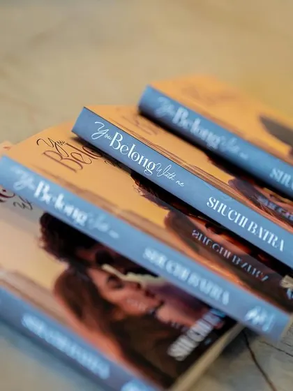 A beautifully arranged stack of books ready for signing, highlighting the professional presentation at our events.