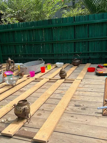 For birthday parties, I bring multiple sensory stations to create a full play zone. This wide view shows a part of our Gruffalo-themed setup, with different areas for scooping, pouring, and pretend play, ensuring there's something for every child.