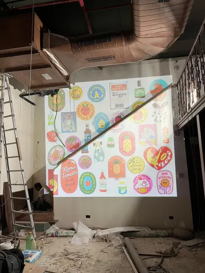 During the construction of Melt House, we used a projector to test out the placement and scale of a large mural. This technique allows us to visualize the final impact of an artwork before it's permanently installed.