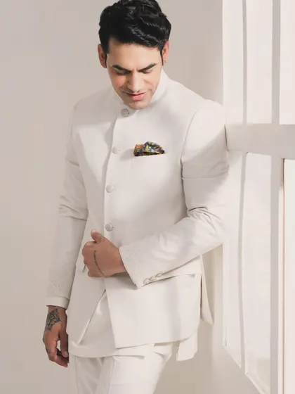 Enjoy the elegance of pastel-themed weddings with this exquisitely crafted white Bandhgala set. It's perfectly tailored for a clean, sophisticated, and celebratory look.
