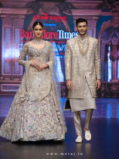 This couple walks the runway in our gold multicolour bridal lehenga and men's gold sherwani. The groom's attire is a testament to exquisite floral embellishments and timeless design.