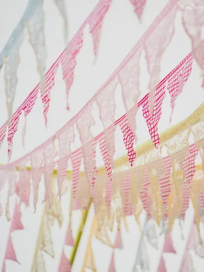 Colorful bunting flags add a playful and festive touch to the 'Picnic in the Mountains' theme.