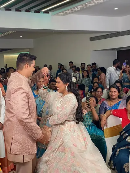 A fun, candid moment during the event, surrounded by happy guests.