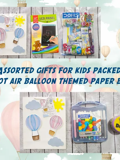 This hot air balloon-themed gift set includes a color set, a Spot It game, and an LCD tablet, all packed in a whimsical themed paper bag.