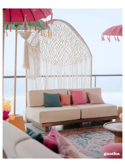 A custom-made macrame arch serves as a beautiful photo backdrop, perfectly complementing the bohemian theme of this Bali Haldi ceremony.